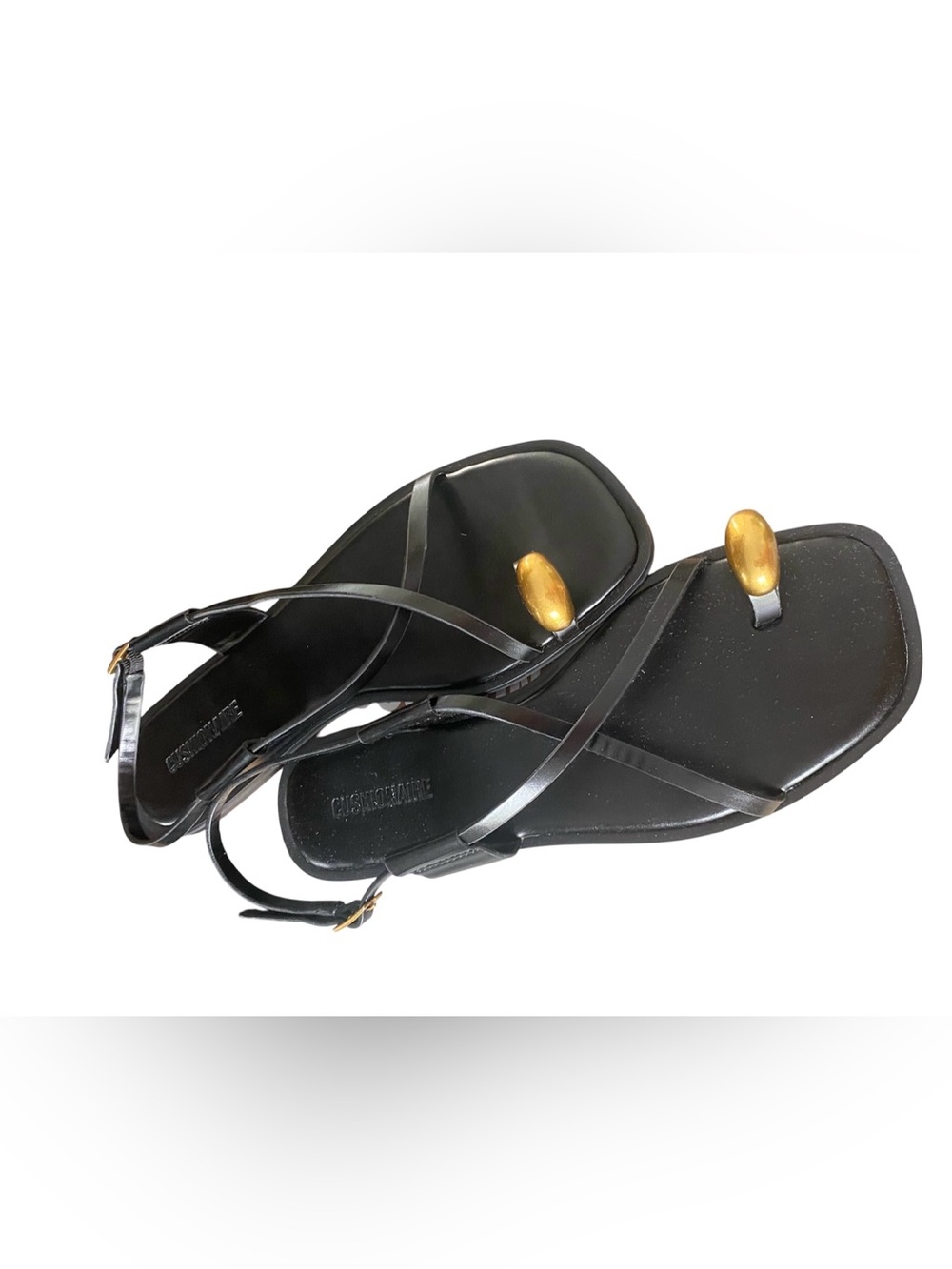 Cushionaire Corfu Black flat sandals with a gold toe ring accent. Leather.